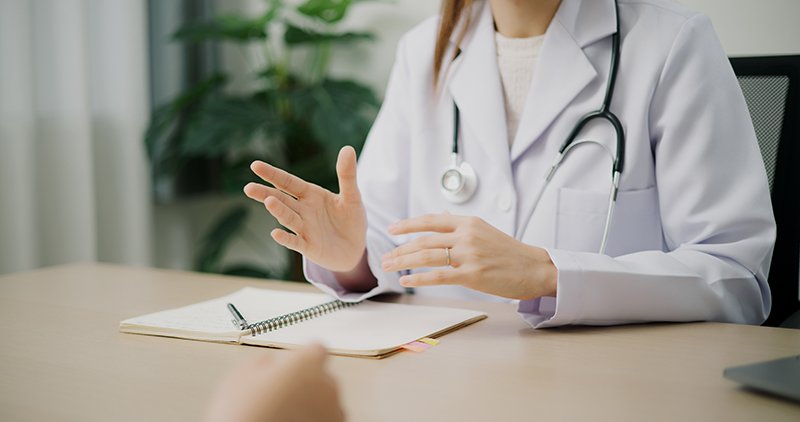 A female dermatologist explaining Ultherapy to a patient.